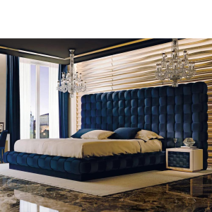 Wide room view of the navy woven headboard with two crystal chandeliers and a gold wavy wall panel